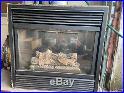 Gas fireplace insert with glass front and logs